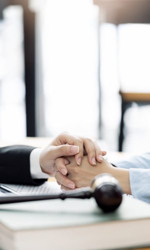 Closeup view of people holding hand together. The judge held the hand of someone who was in trouble to cheer them on. Encouragement concept.